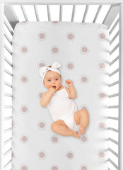 Elastic bottom edge demonstrated for a secure fit on standard cribs and toddler beds.