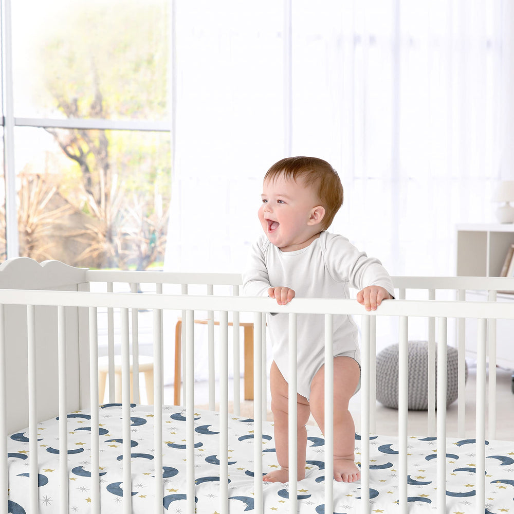 Sweet Jojo Designs Moon Star satin crib sheet in a cozy nursery setup with celestial decor.