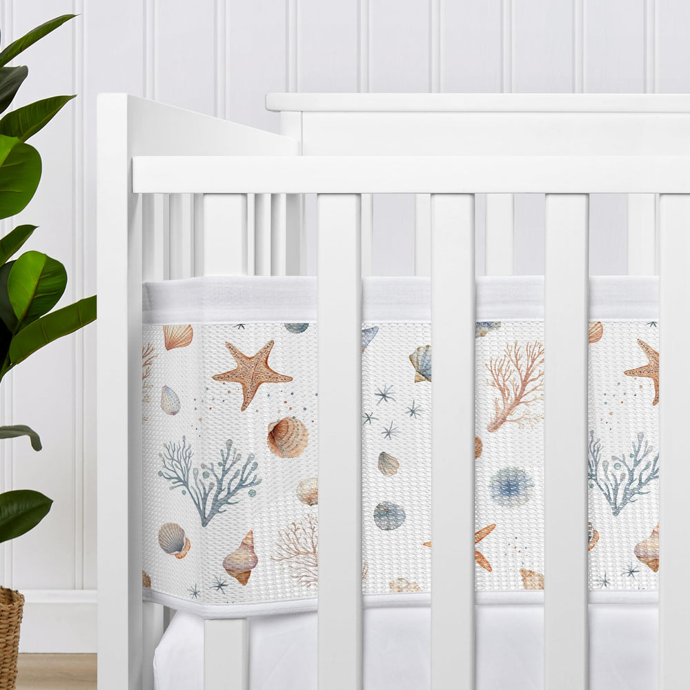 Sweet Jojo Designs Ocean Seashells visual shield promotes calmer nursery sleep.