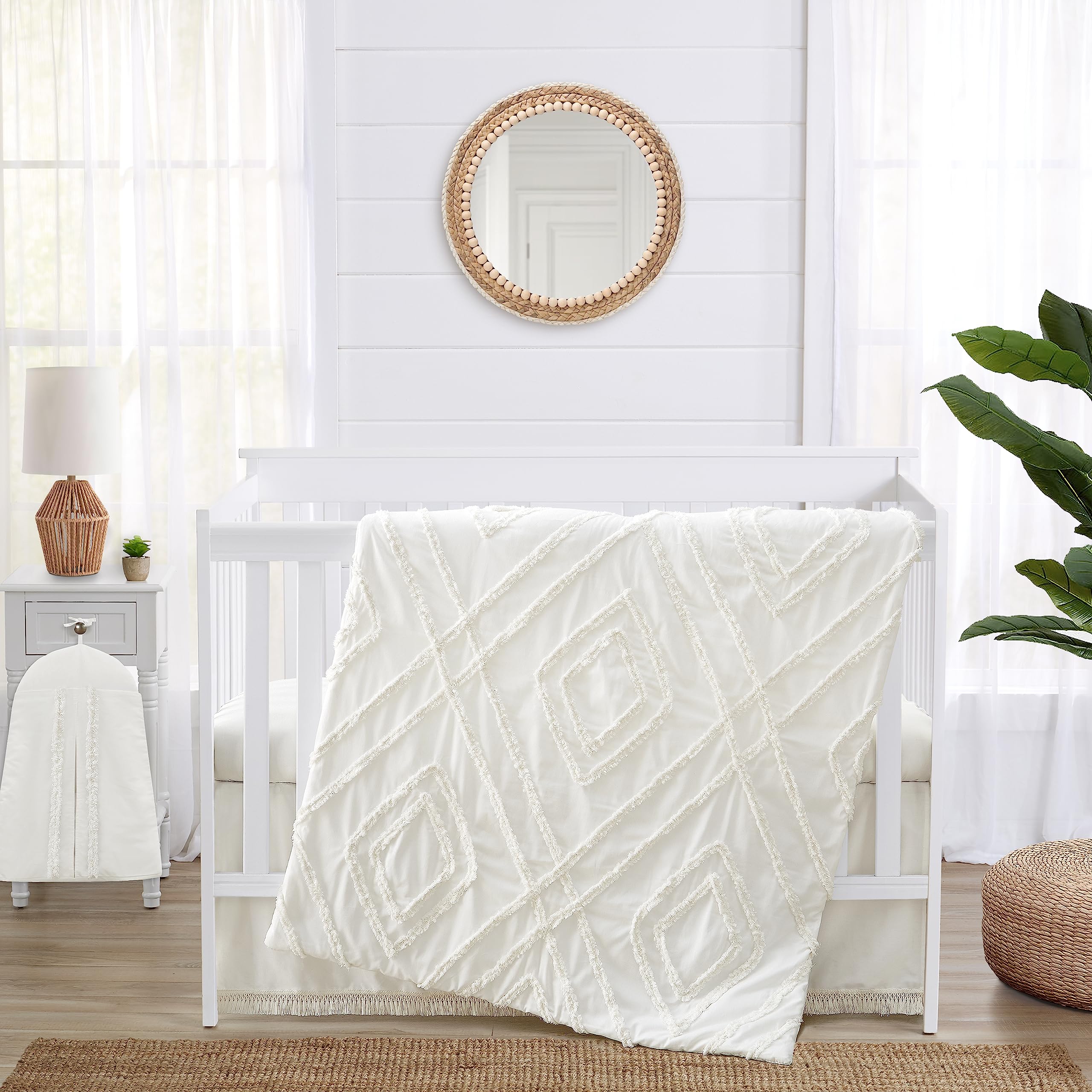 Sweet Jojo Designs off-white crib blanket with macrame trim for cozy nursery decor.