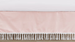 Sweet Jojo Designs pink boho crib skirt draped on a standard crib for a polished nursery.