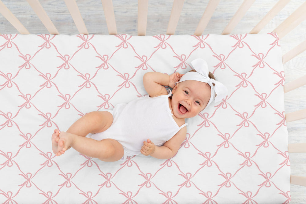 Sweet Jojo Designs pink bows brushed-microfiber sheet; breathable comfort for naps.