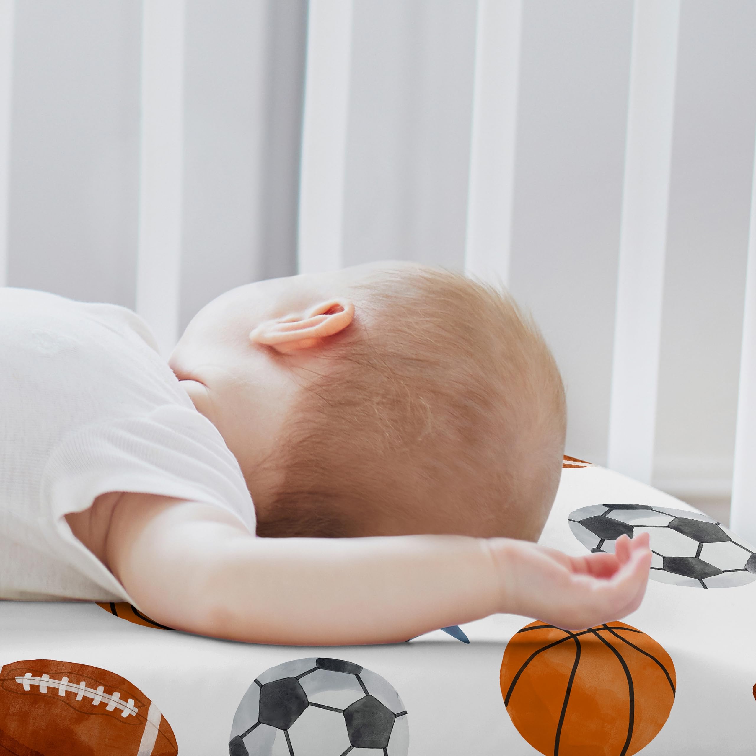 Sweet Jojo Designs sport-theme bassinet sheets blue watercolor print adds playful nursery flair.