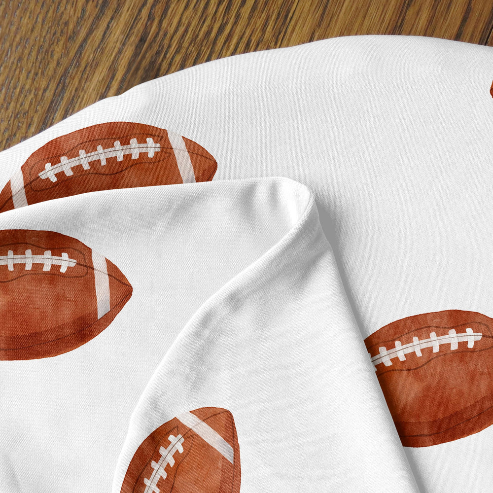Sweet Jojo Designs sports-themed nursery decor complements newborn feeding moments daily.