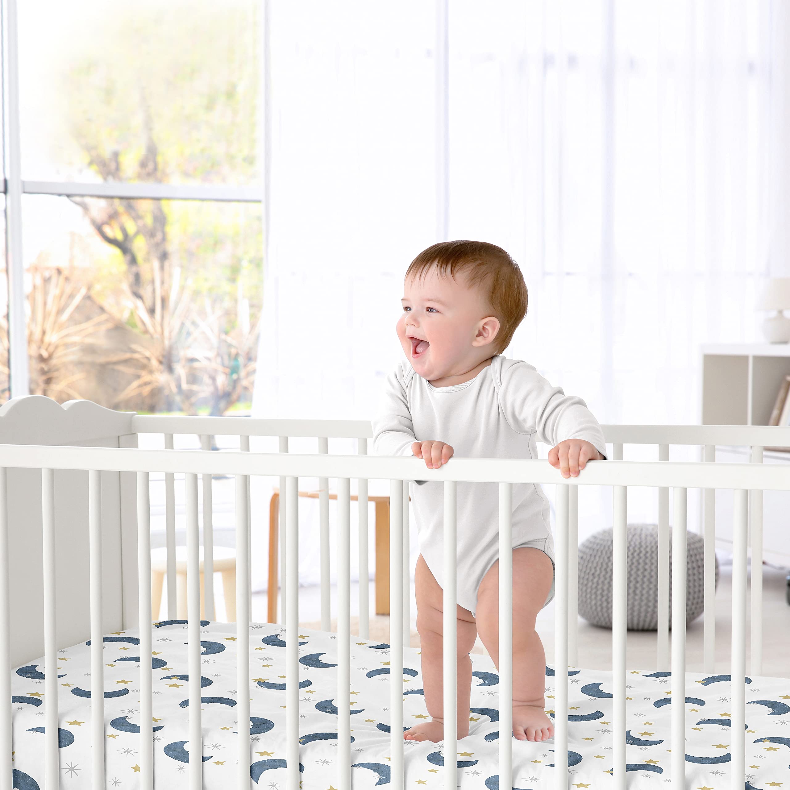 Sweet Jojo Designs watercolor celestial print adds calming nursery aesthetics.