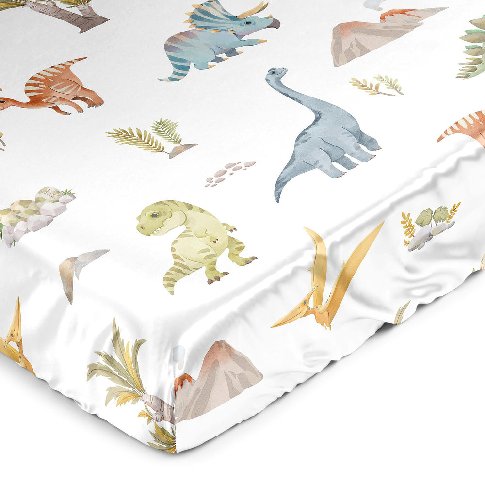 Sweet Jojo Designs watercolor dinosaur sheet closeup — satin fabric feels gentle on delicate hair.