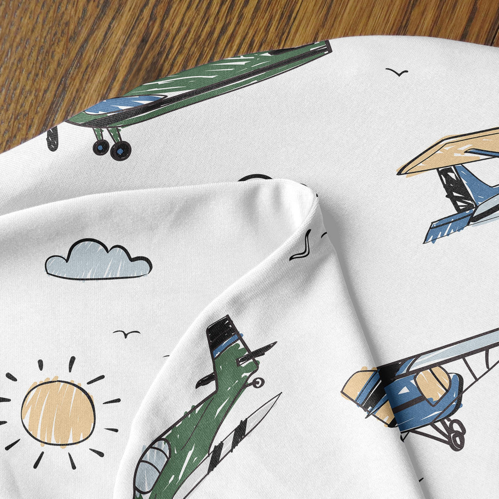 Sweet Jojo Designs nursing cover on a pillow in a cozy nursery setup.