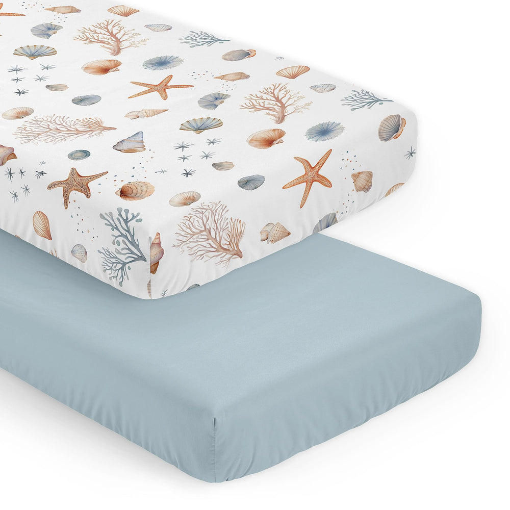 Sweet Jojo Designs Ocean Seashells crib sheets close-up of watercolor seashells for gentle, breathable sleep.