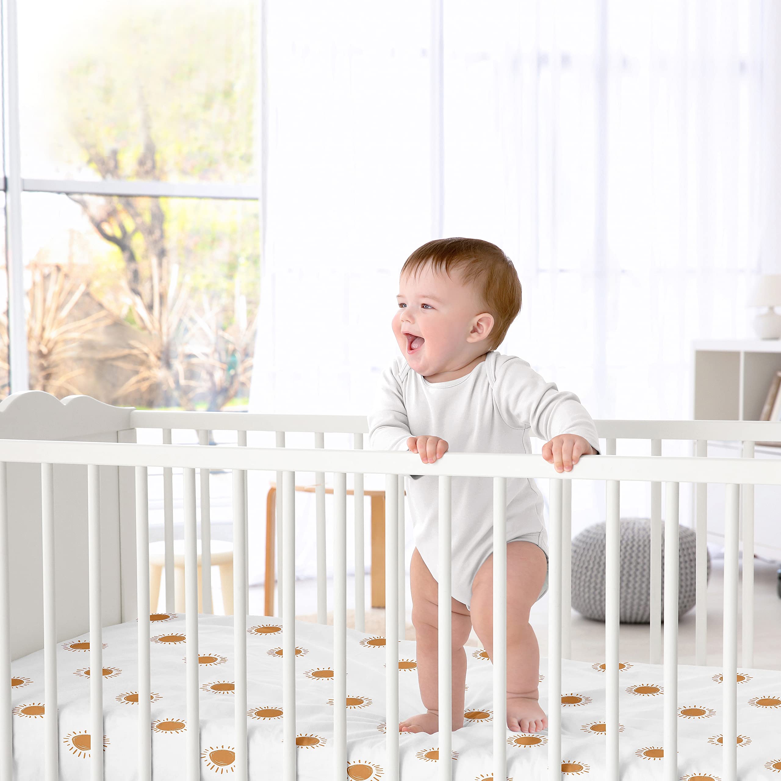 Sweet Jojo Designs orange-white boho sun satin sheet showcased in nursery setting