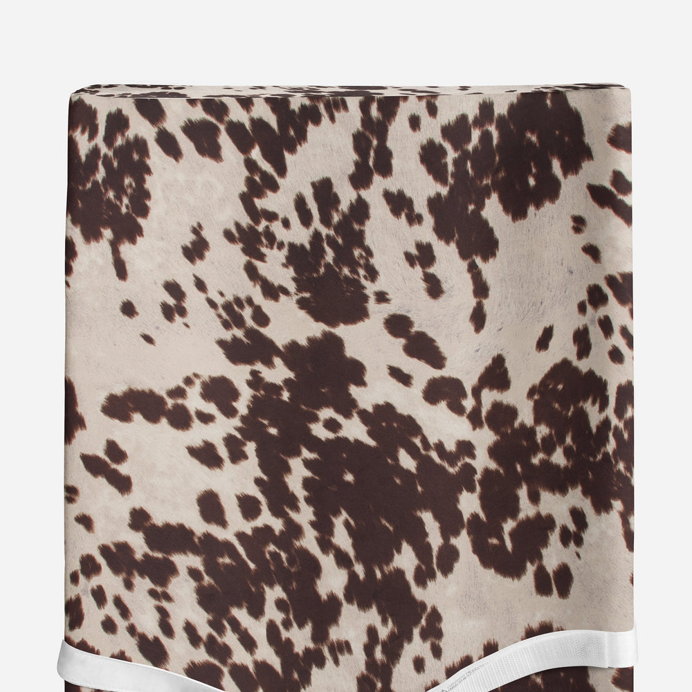 Sweet Potatoes Western Cowboy cowprint close-up highlighting durable fabric and cozy touch for baby care.