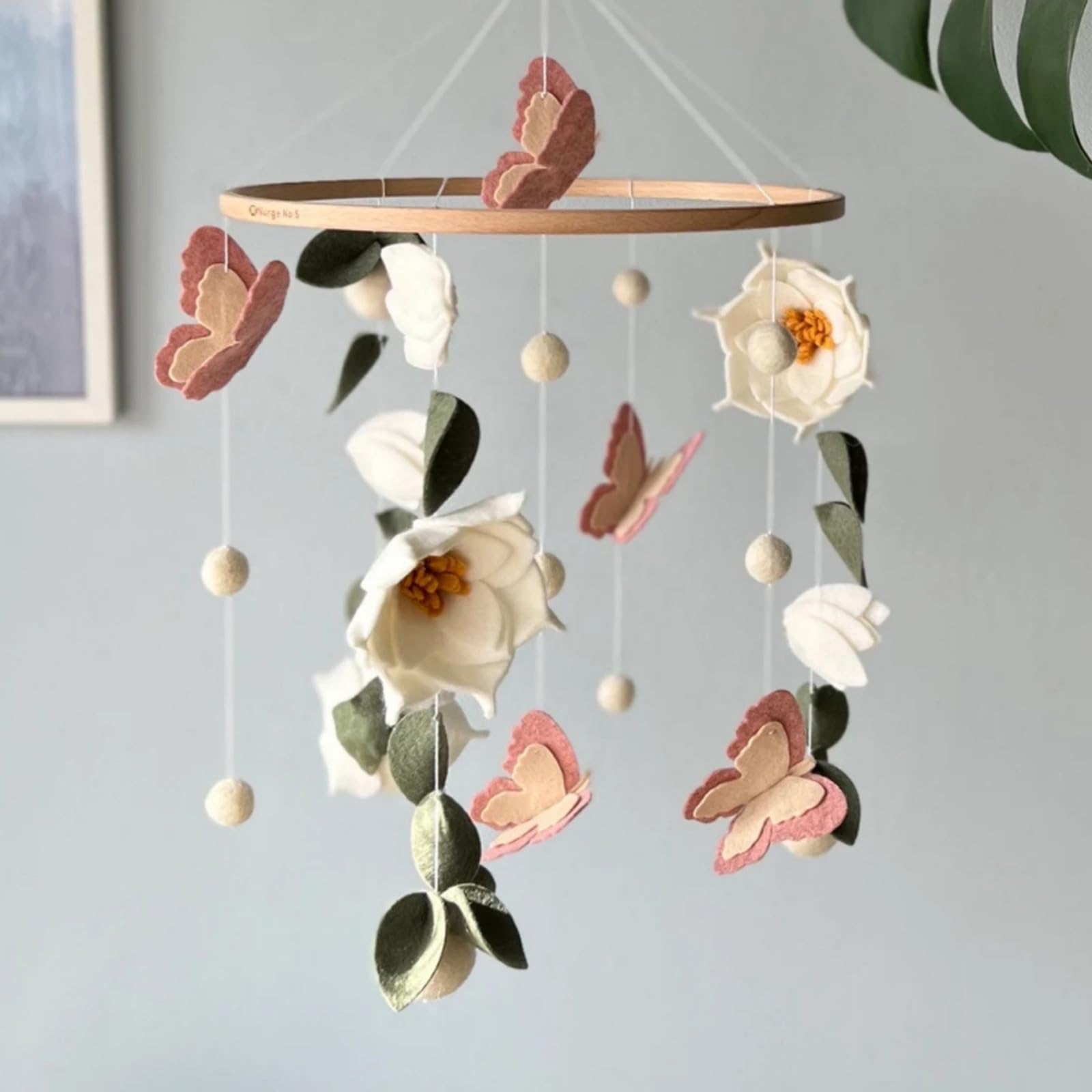 SWECOMZE nursery ambience—lush leaves and delicate petals create a soothing focal point