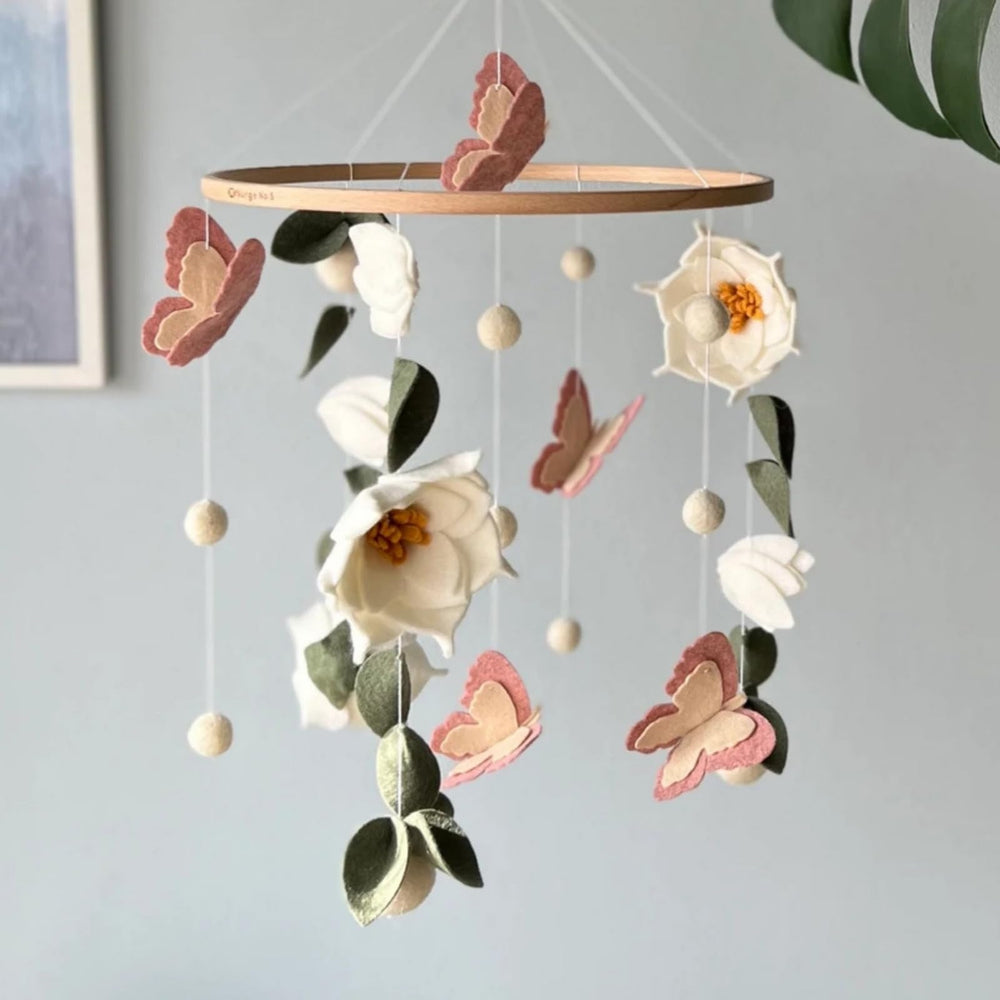 SWECOMZE nursery ambience—lush leaves and delicate petals create a soothing focal point