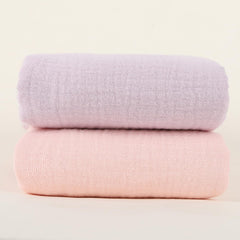 Synrroe baby nursery scene shows soft-touch blanket in crib.