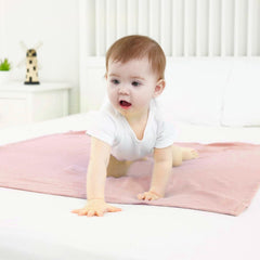 Synrroe muslin swaddle blanket 40x40 inches floral pink, folded to reveal breathable layers for year-round comfort.