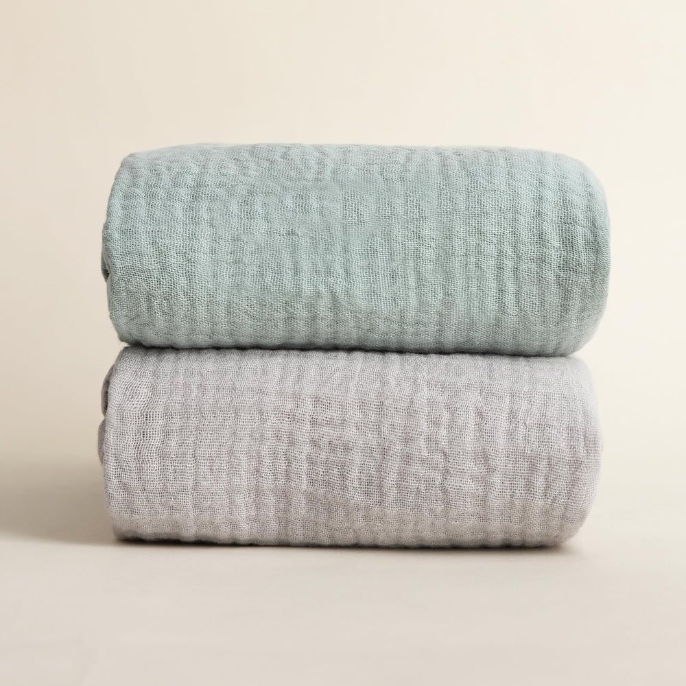 Synrroe muslin swaddle blanket showcases neutral colors complementing nursery decor