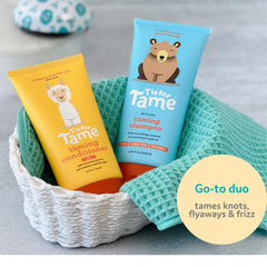 T is for Tame Taming Conditioner bottle dispensing for detangling and smooth curls.