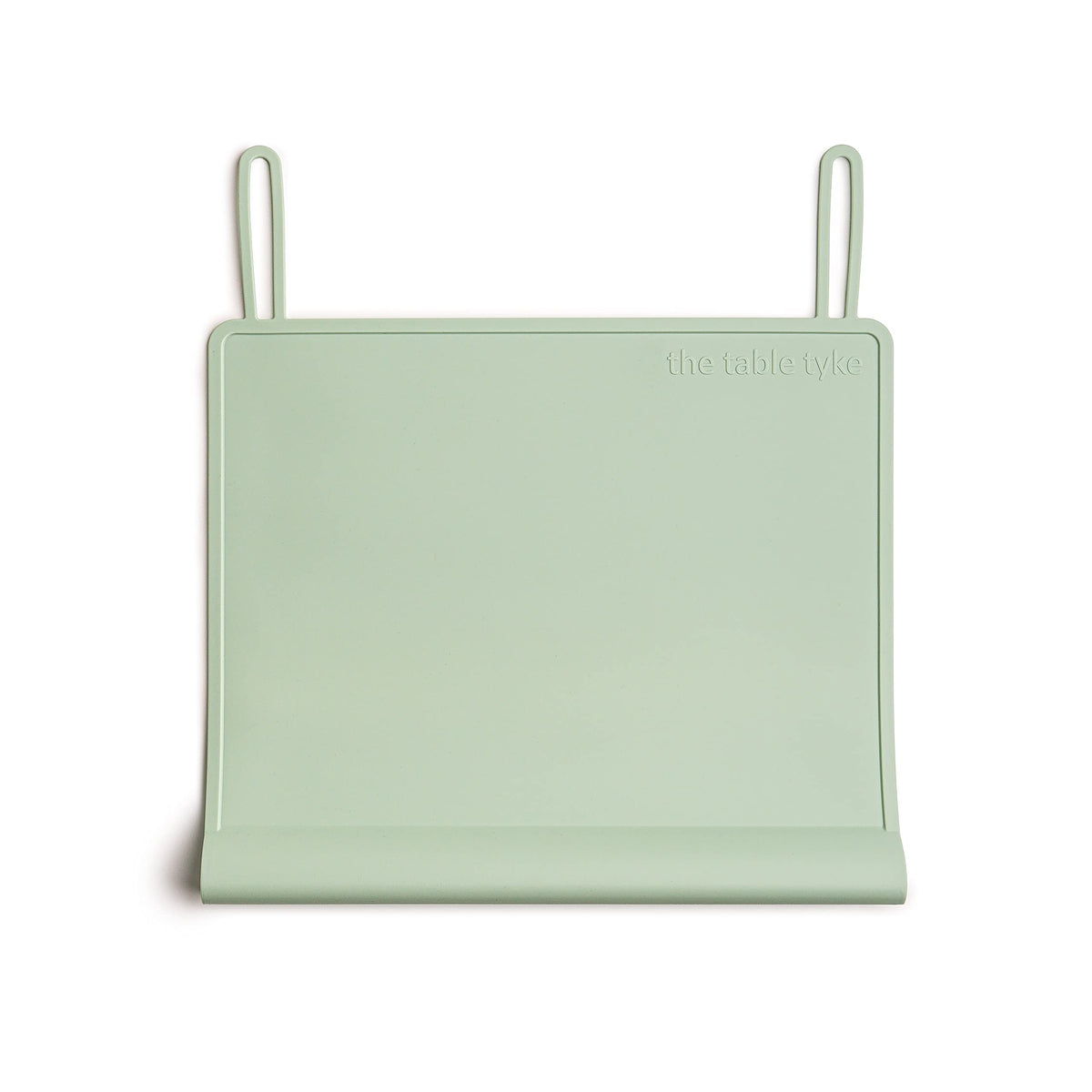The Table Tyke silicone placemat in sage green lies flat for everyday meals and quick cleanup.