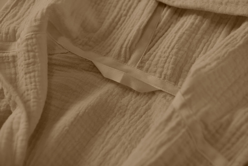TADO MUSLIN bathrobe care shot demonstrates quick drying with machine wash capability