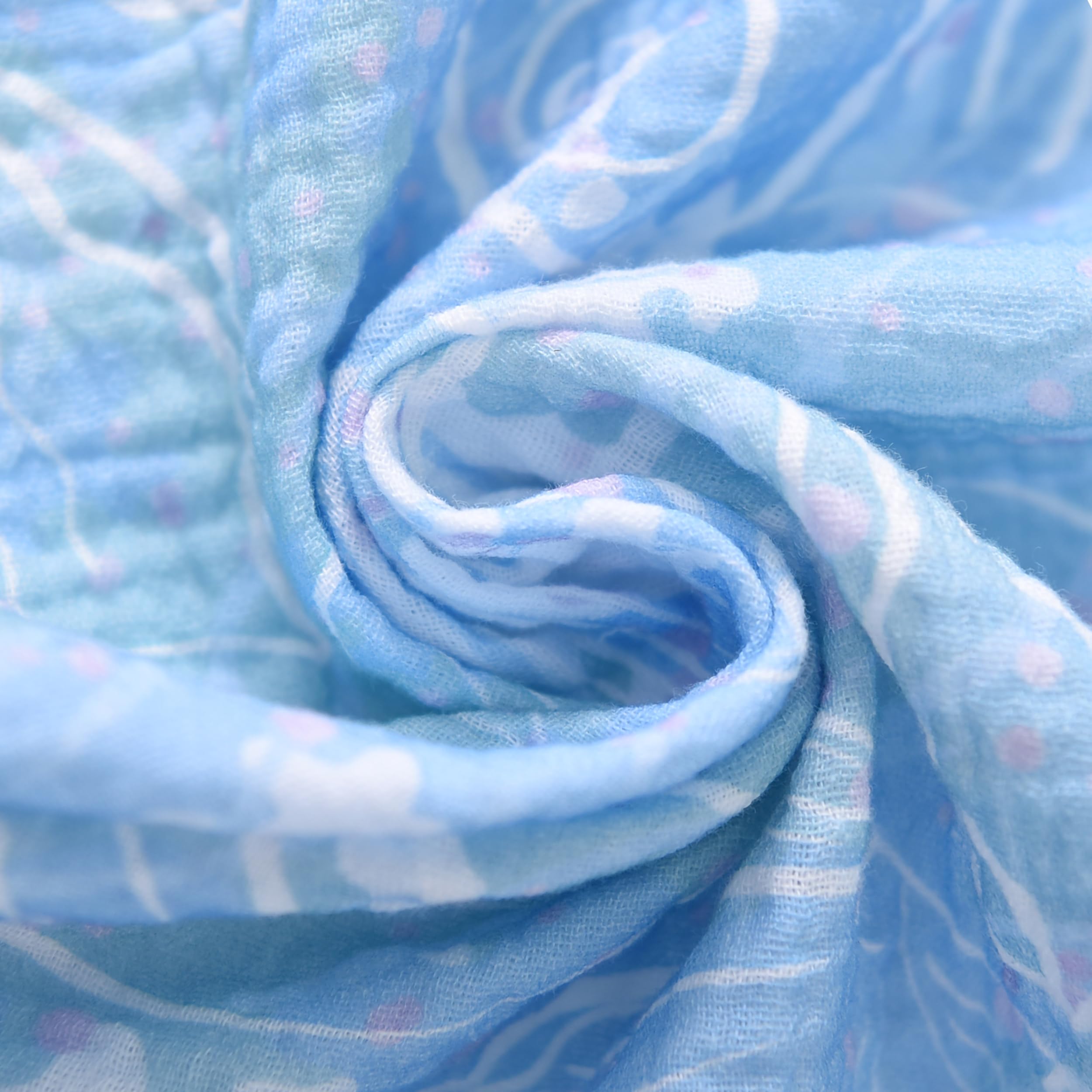 TADO MUSLIN crib sheet soft texture against baby's skin close-up