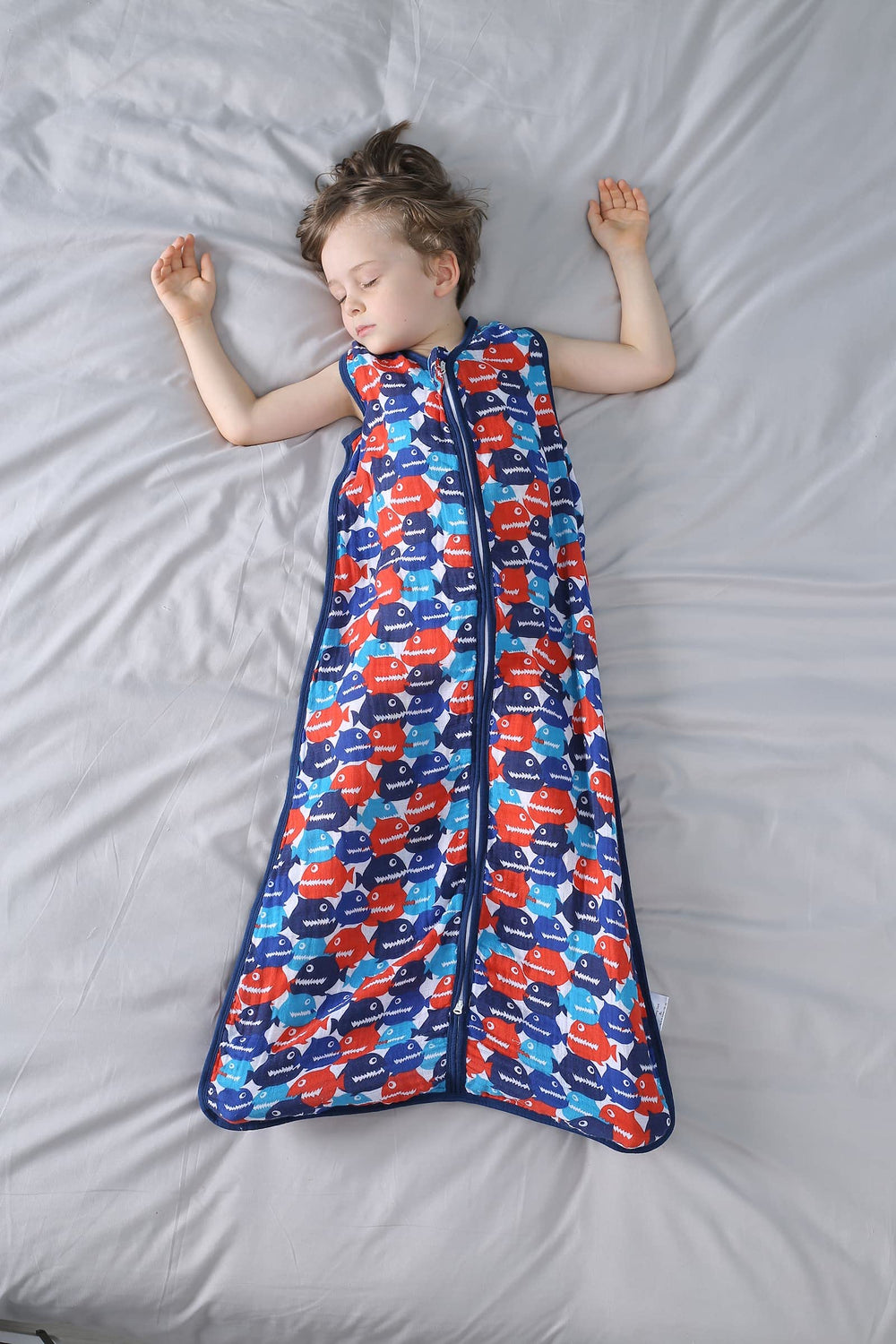 TADO MUSLIN model toddler wearing the sleeping sack for cozy, all-night comfort.