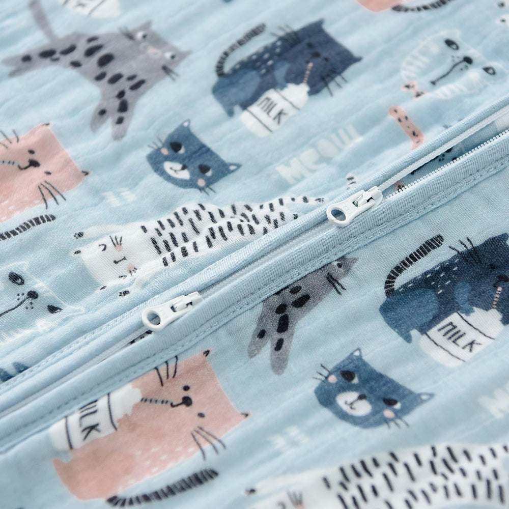 TADO MUSLIN baby wearing sack on crib demonstrates roomy design for movement