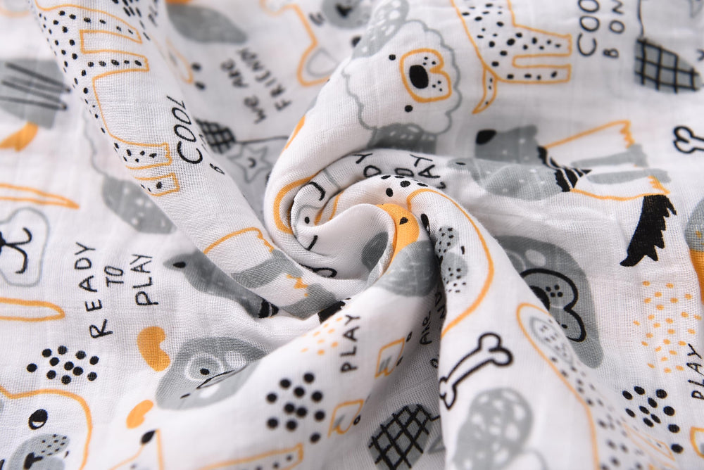 TADO MUSLIN swaddle blanket closeup-soft-texture highlights breathable organic cotton against baby's skin.