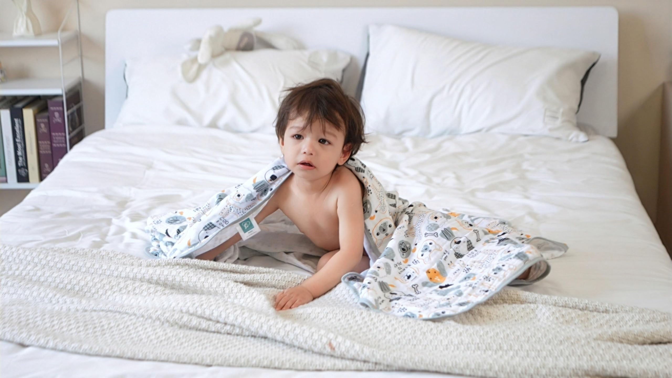 TADO MUSLIN swaddle blanket wrapped-baby demonstrates secure snug wrap and easy nursing cover versatility.