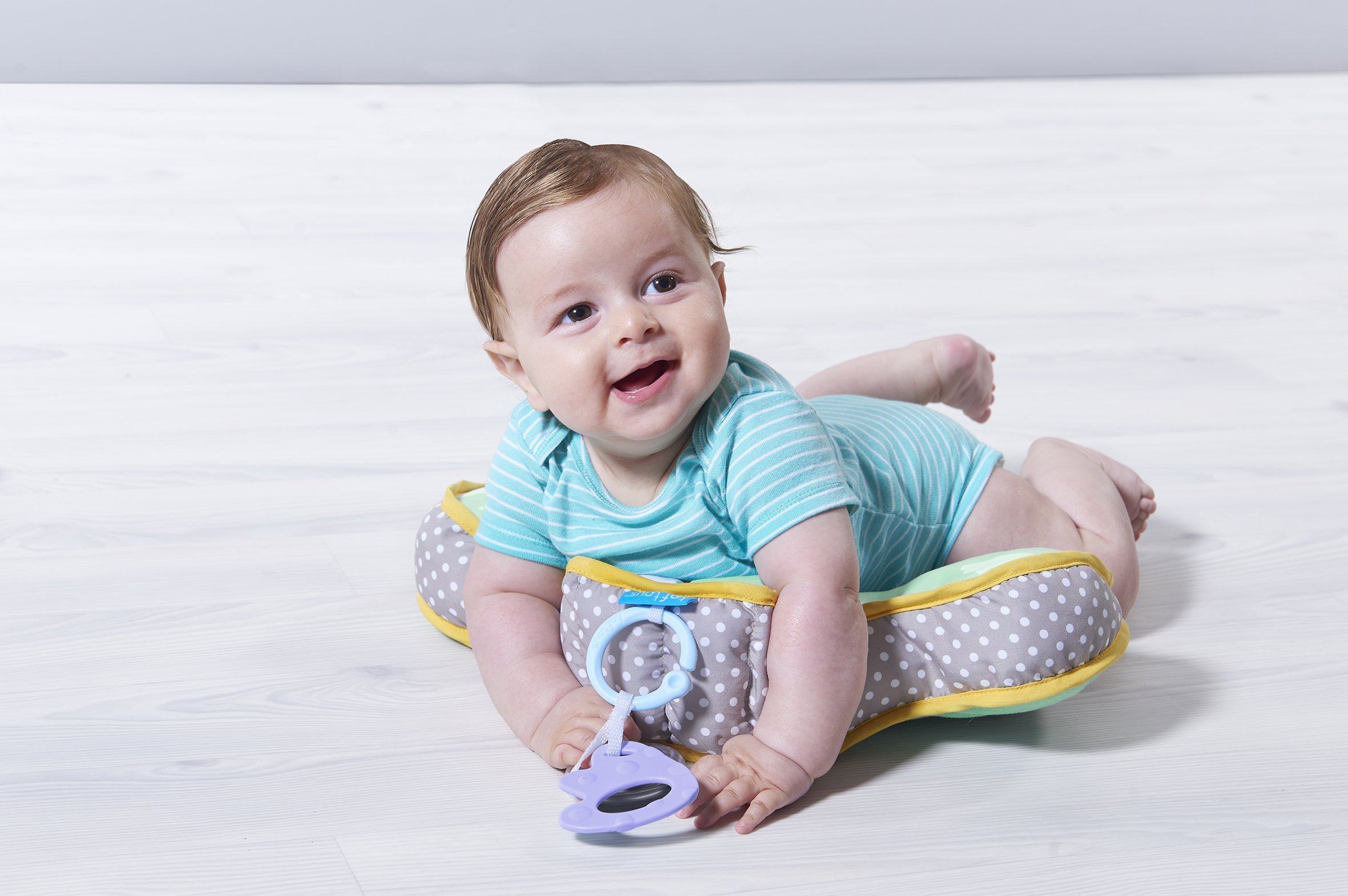 Taf Toys tummy time cushion side view highlights gentle elevation for comfortable play.