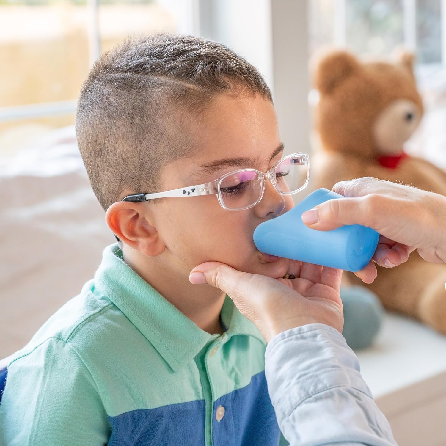 Child using TalkTools Cut Out Cup Blue during mealtime practice.