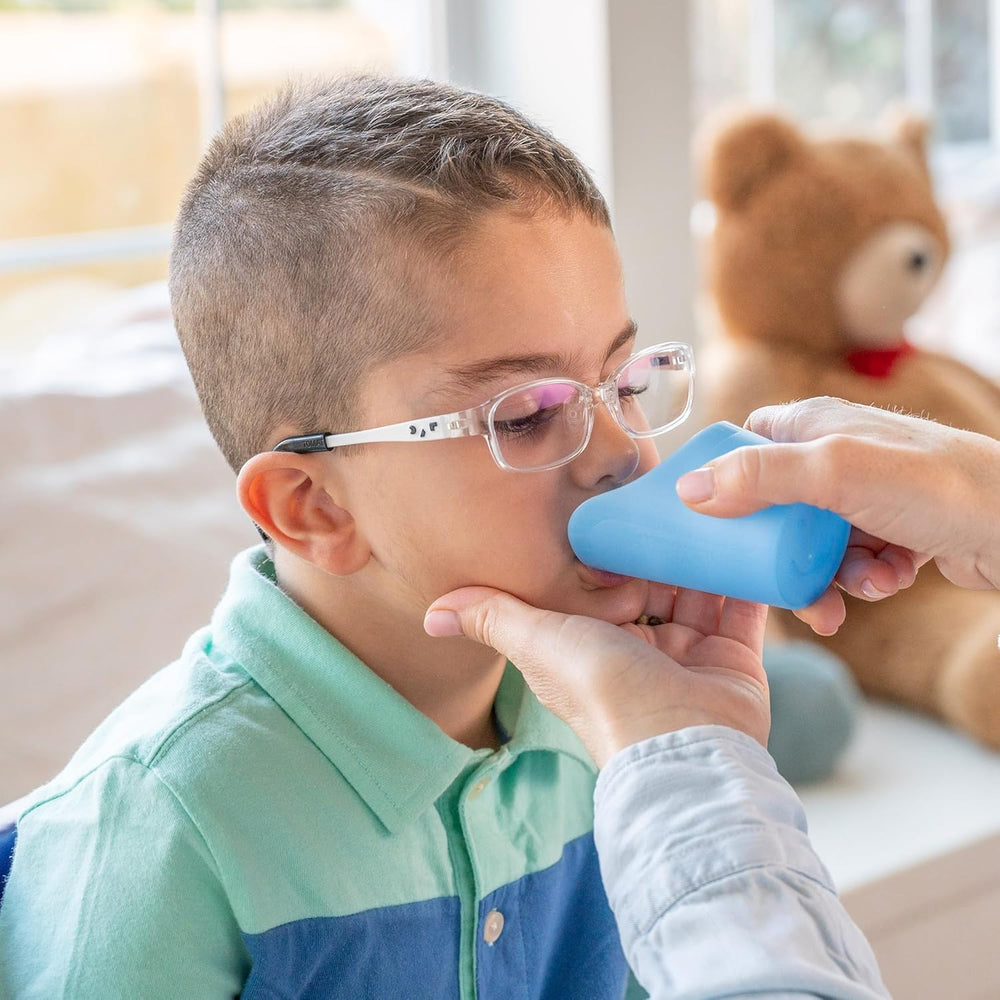 Child using TalkTools Cut Out Cup Blue during mealtime practice.
