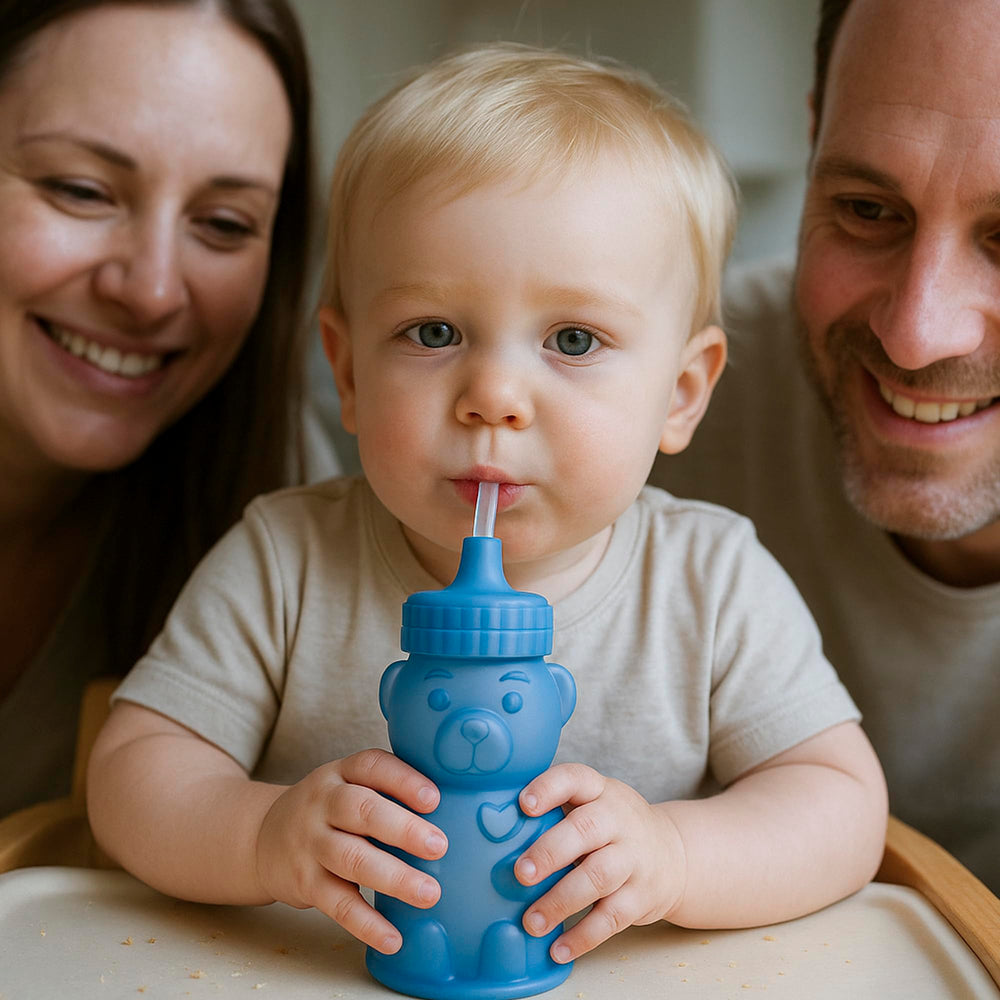 TalkTools Honey Bear cup in use with toddler hands showing durable, splash-minimizing straw training