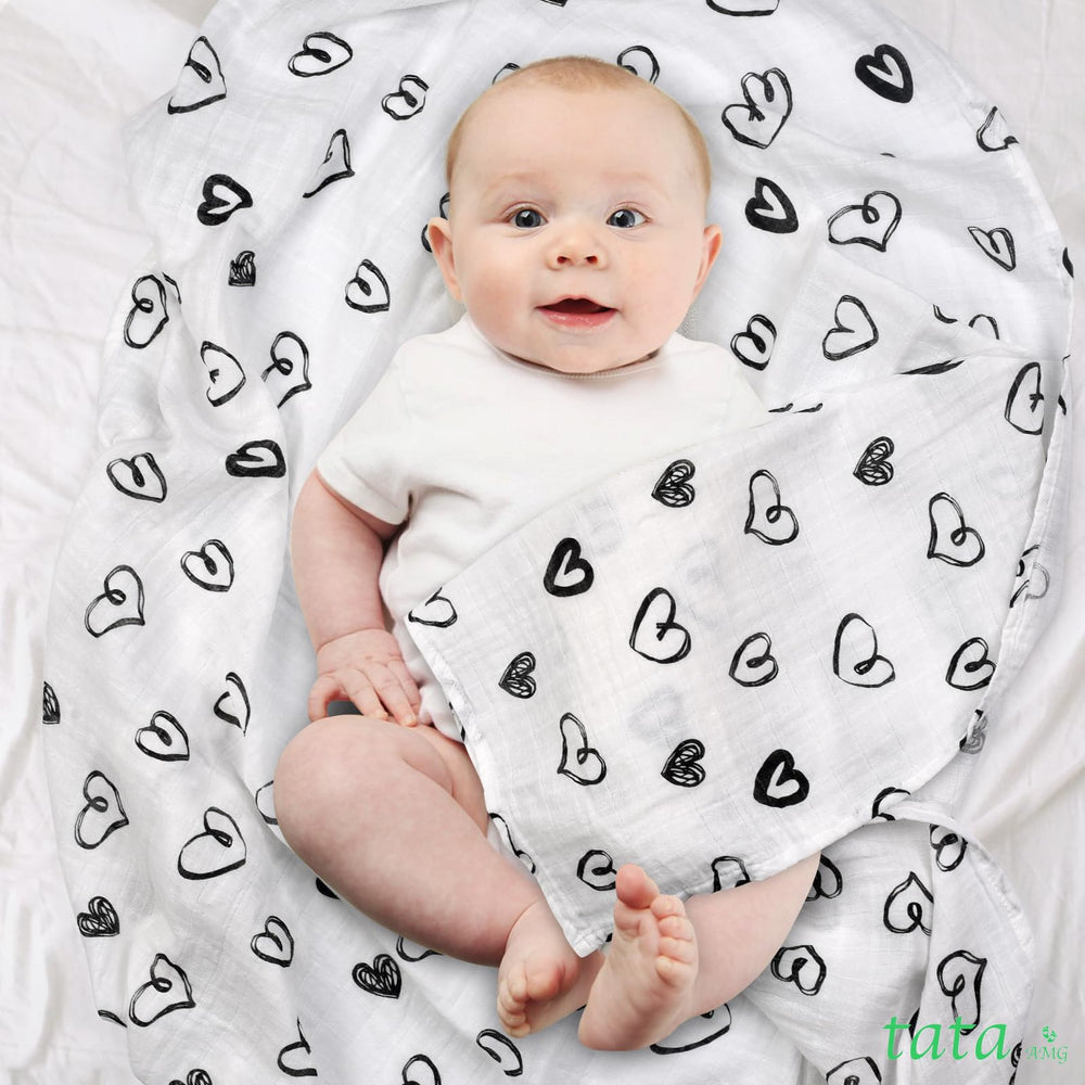 TATA AMG muslin swaddle blanket wrapped around baby highlighting breathable fabric.
