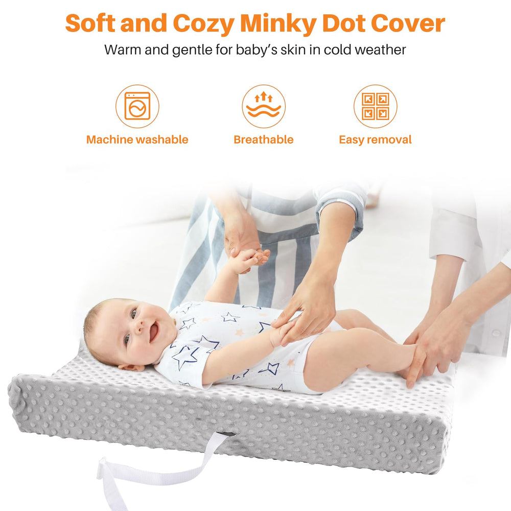 tauuio changing pad safety belt buckle image conveys secure positioning during changes.