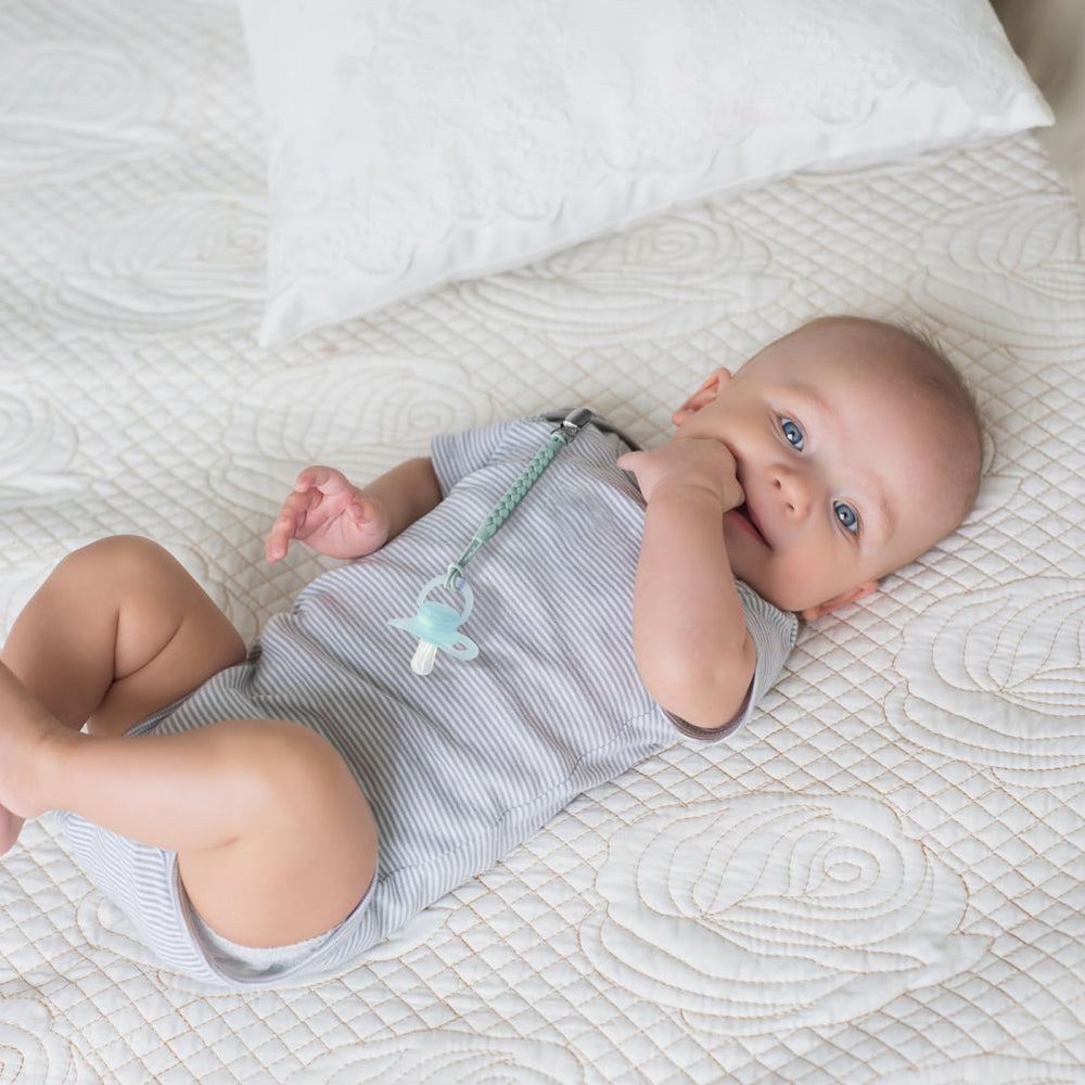 Tender Babe pacifier clip on baby clothing demonstrates gentle, fabric-friendly attachment.