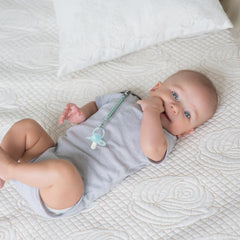 Tender Babe pacifier clip on baby clothing demonstrates gentle, fabric-friendly attachment.
