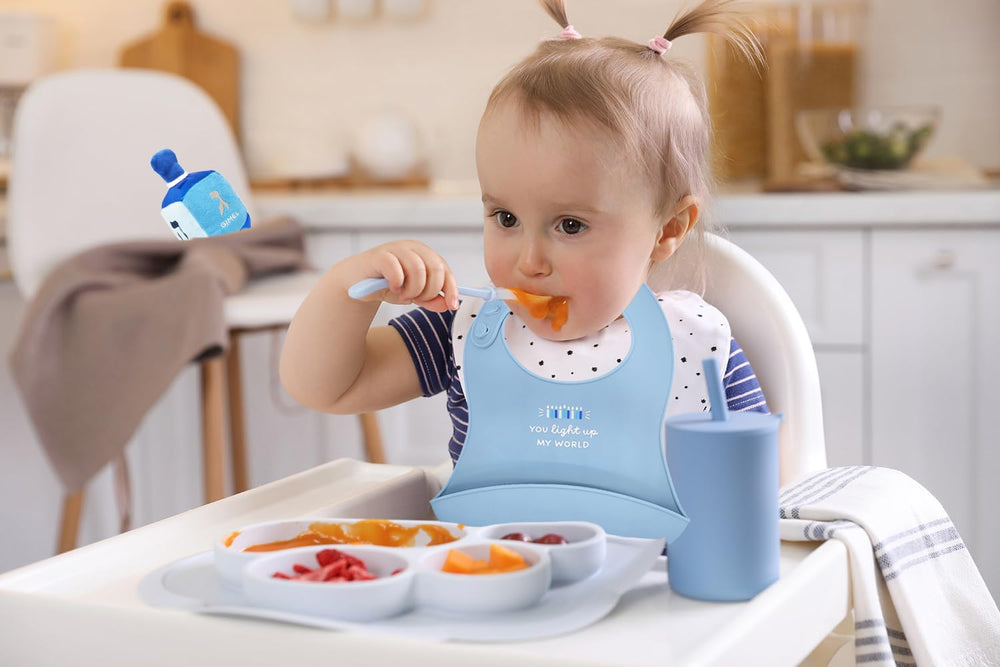 The Dreidel Company Hanukkah bib is unisex and comfortable for kids.