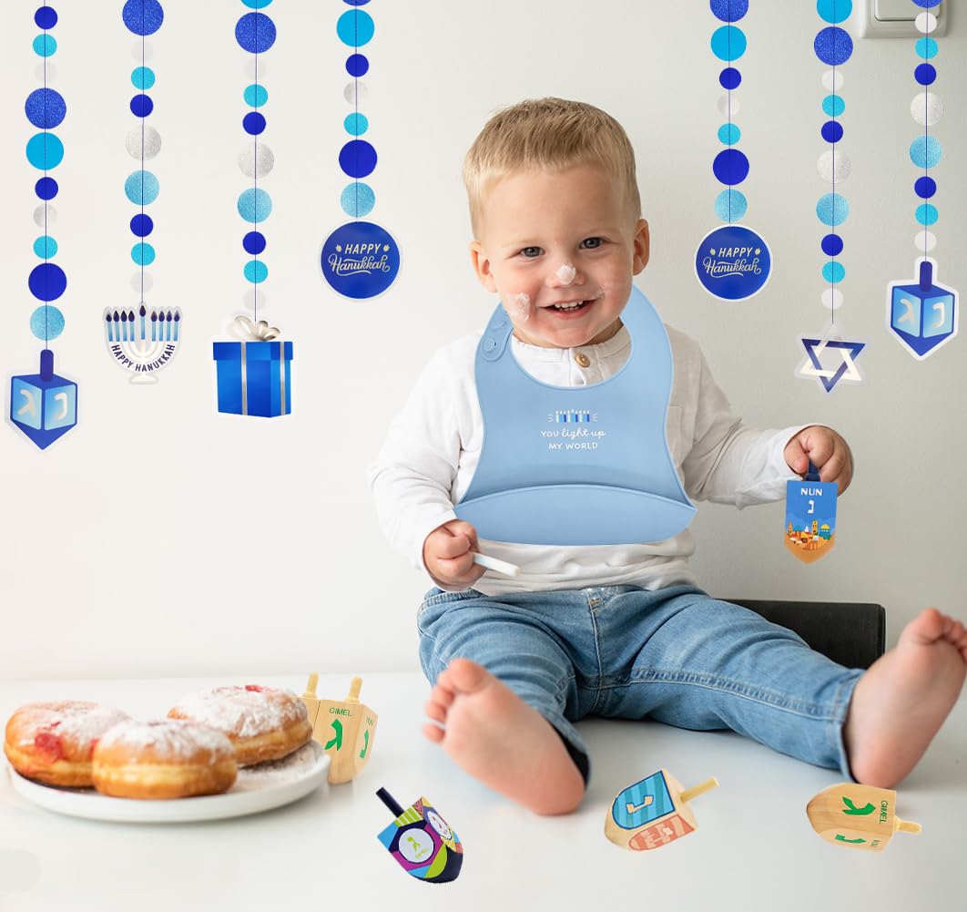 The Dreidel Company bib's deep spill pocket reduces table mess during snacks.