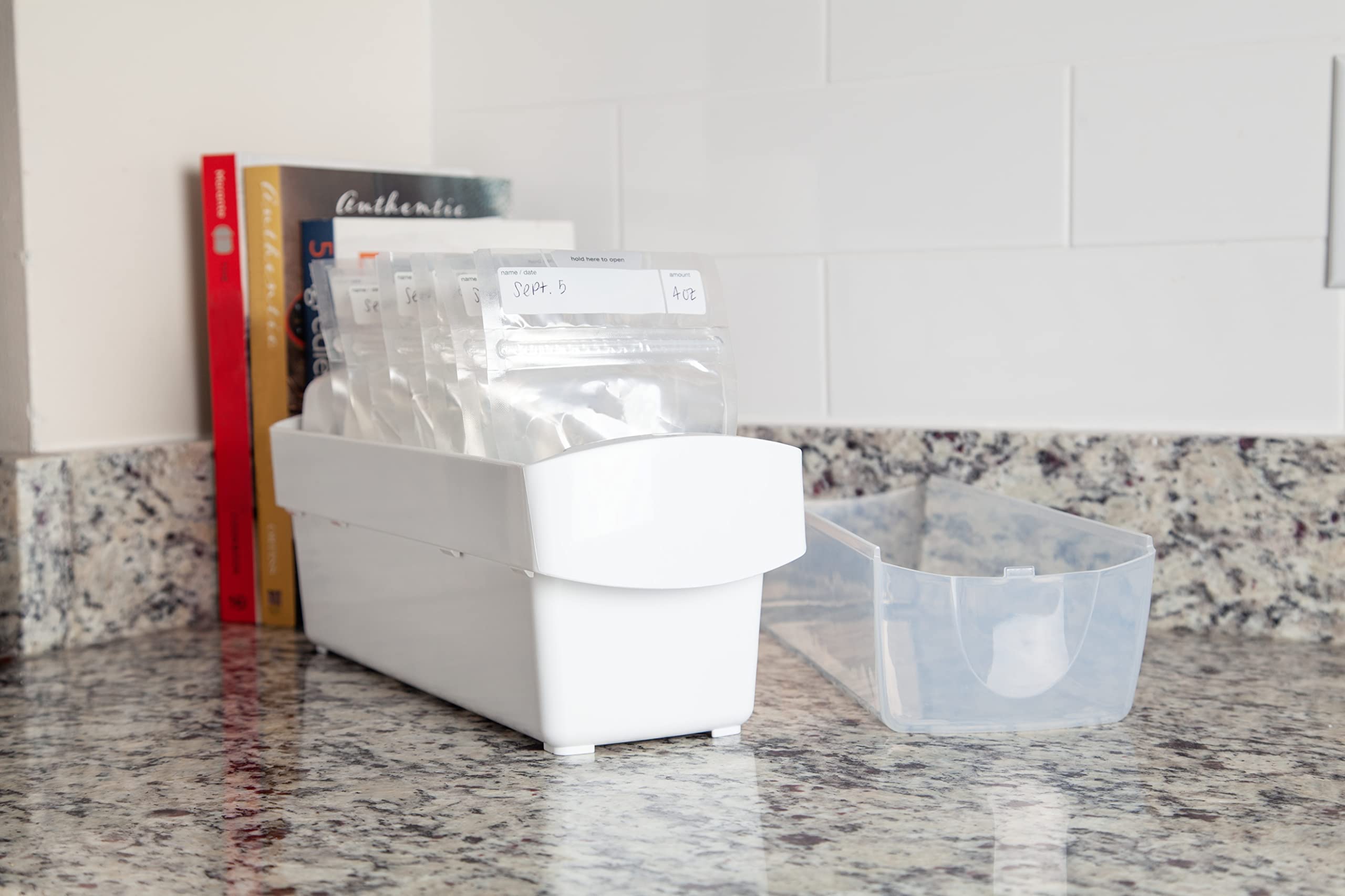 The First Years Breastflow Freezer Organizer in use on a freezer shelf showing FIFO flow.