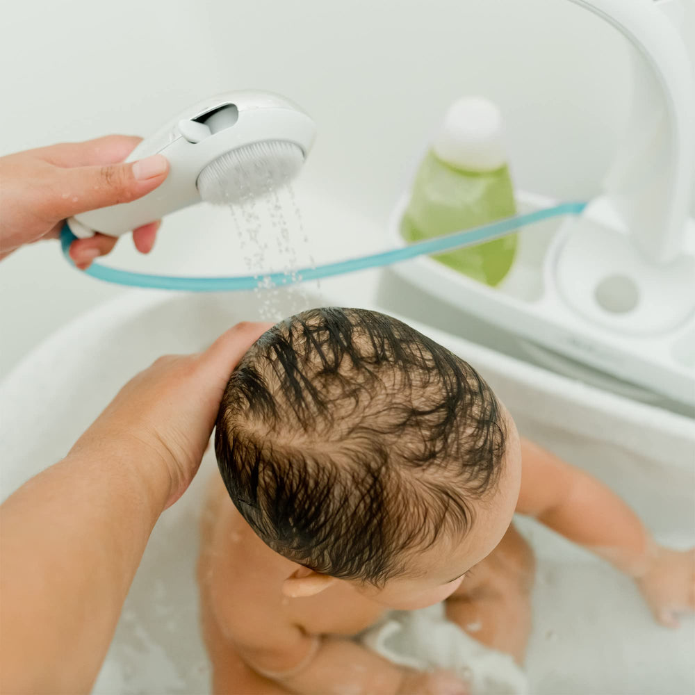 The First Years Rain Shower Head handheld control enables custom, gentle rinsing during baby baths.