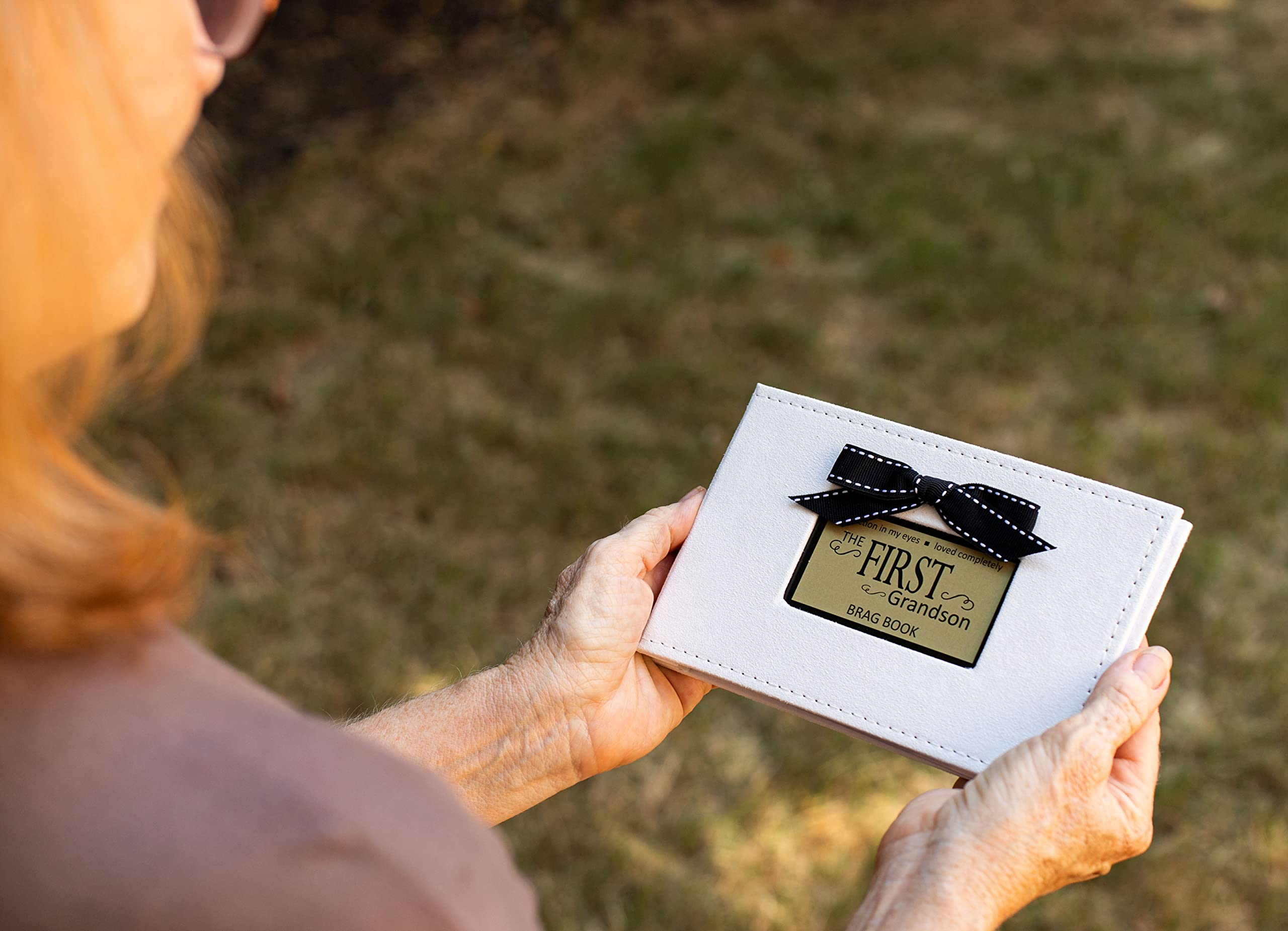 The Grandparent Gift Co. brag book open page displays room for cherished first-grandson photos.