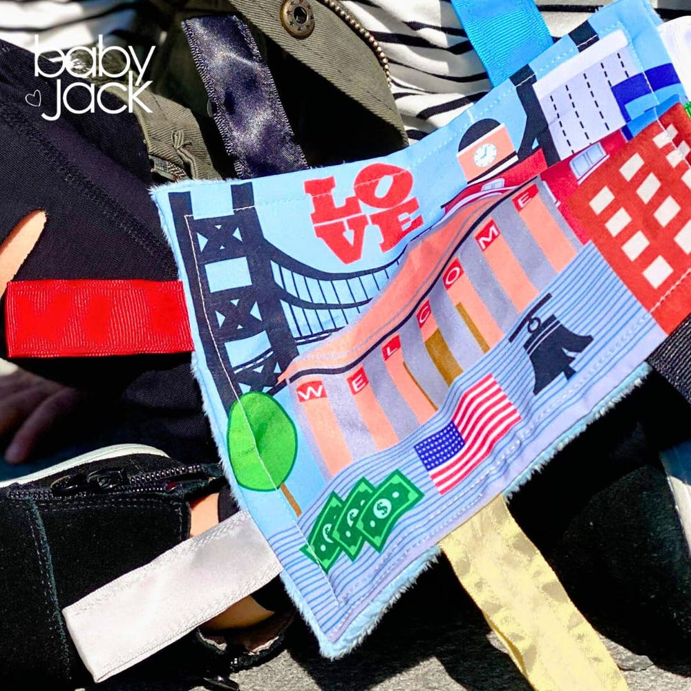 The Learning Lovey city-themed tag toy supports portable play on trips.