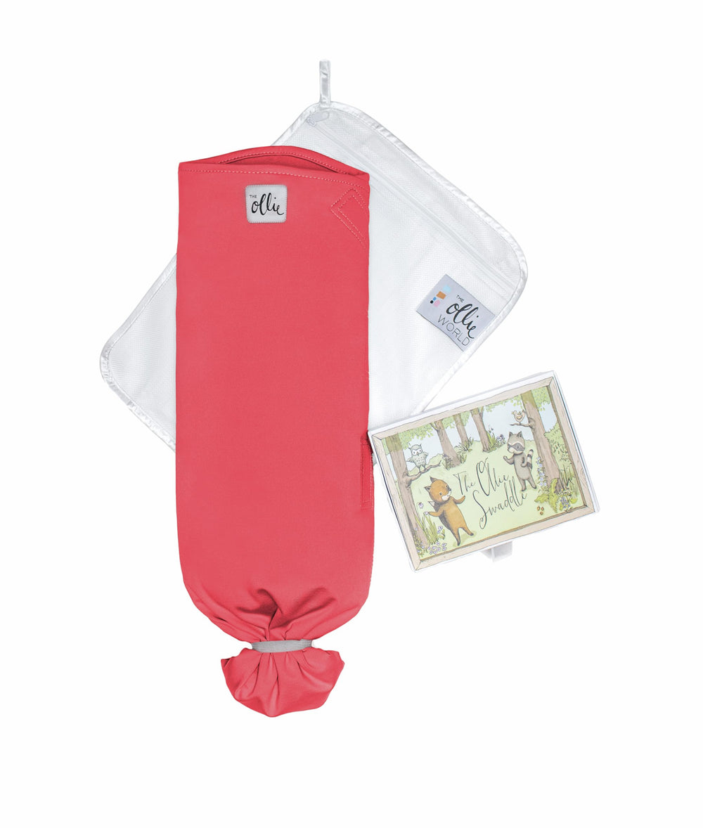 The Ollie Swaddle arms-in fit illustrates secure adjustable closures for healthy shoulder movement.
