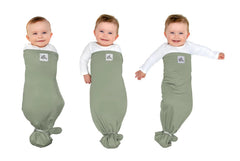 The Ollie Swaddle arms-in setup shows snug adjustable fit for newborn sleep