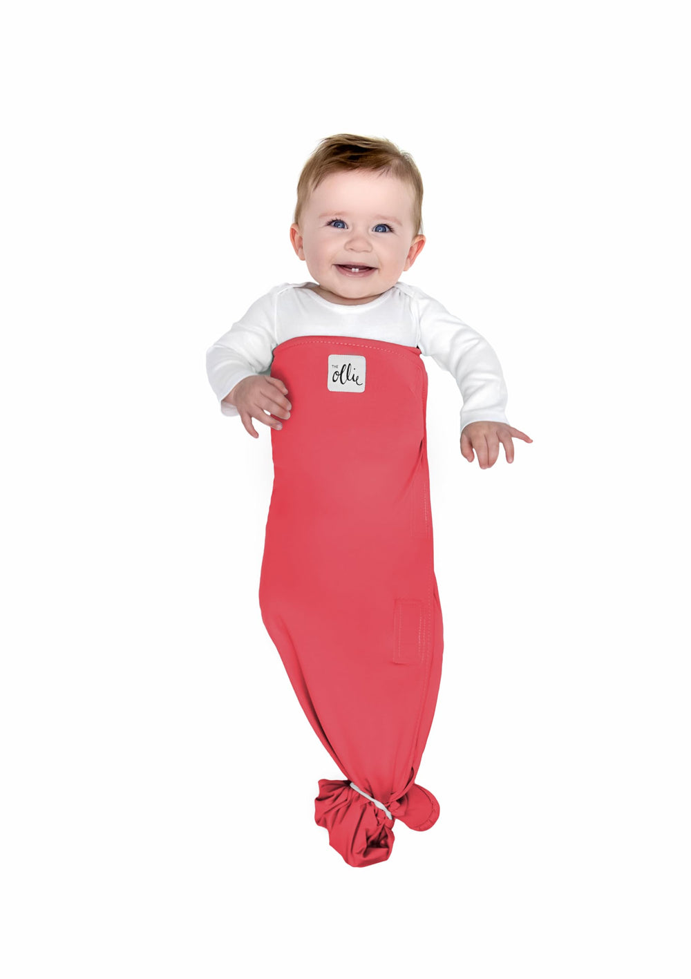 The Ollie Swaddle arms-out fit shows flexible design supporting baby’s natural arm position.