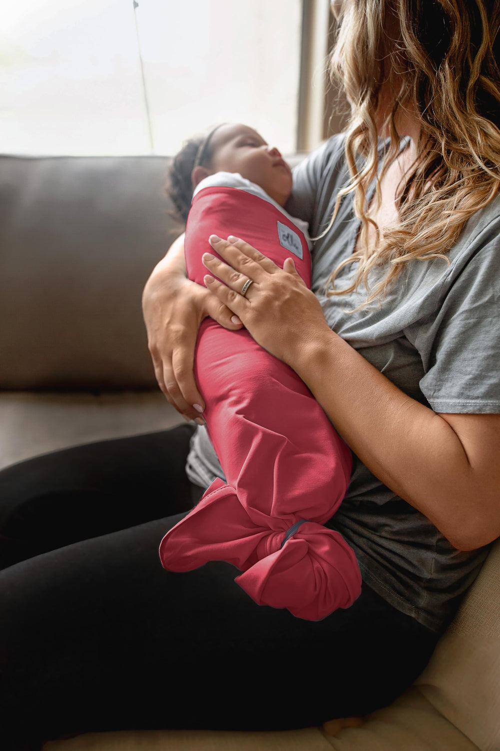 The Ollie Swaddle machine-washable image emphasizes easy care with included mesh bag.