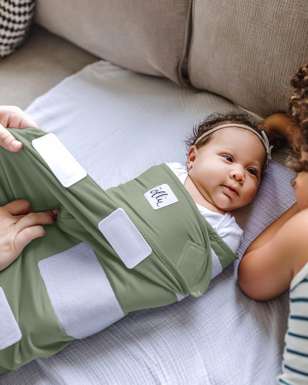 The Ollie Swaddle open-bottom design enables quick diaper changes