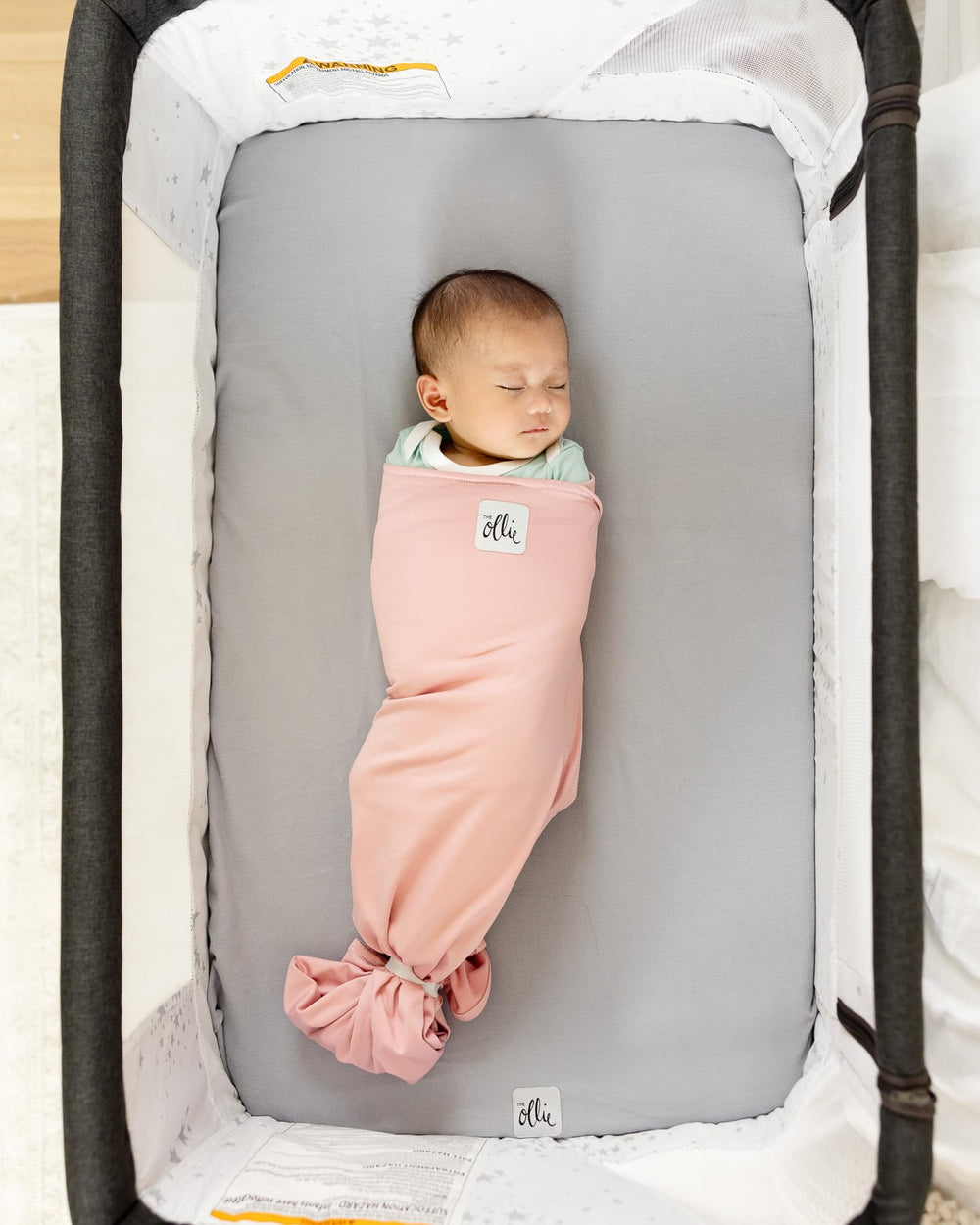 The Ollie Swaddle open-bottom design enables quick diaper changes with minimal disturbance.