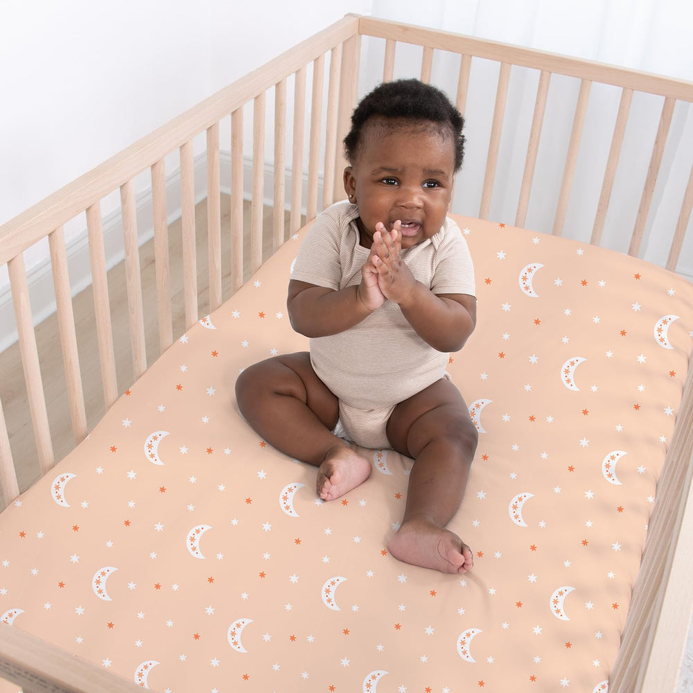 The Peanutshell celestial-prints sheet offers a calm, breathable surface for bedtime routines.