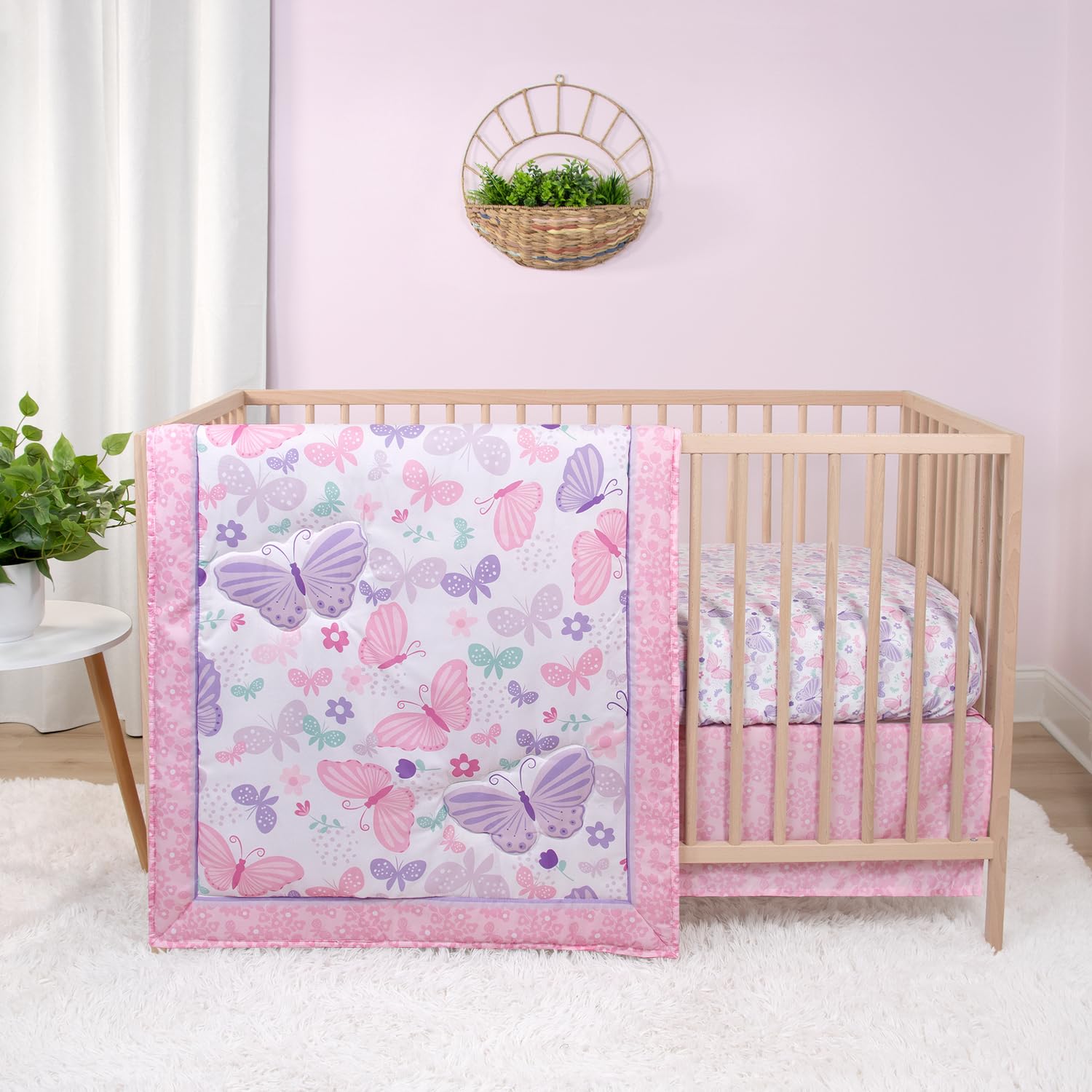 The Peanutshell Butterfly Song crib quilt in soft pinks for cozy newborn snuggles.