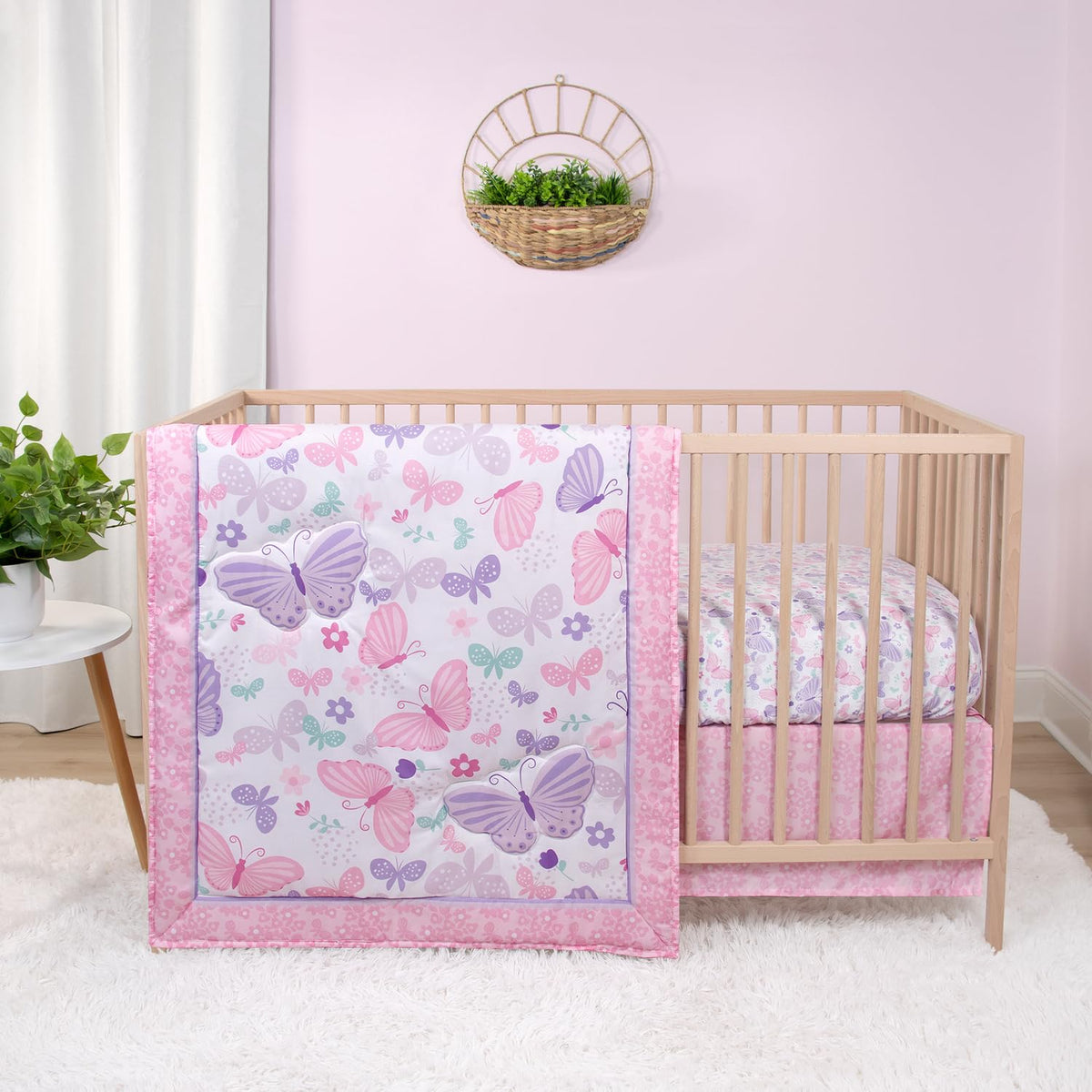The Peanutshell Butterfly Song crib quilt in soft pinks for cozy newborn snuggles.